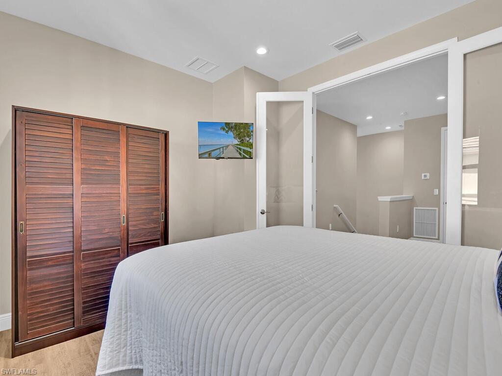 2561 Seychelles Drive, Unit 308 Naples, FL 34112 - Photo 17 of 28 a large white bed in a white room