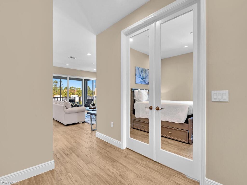 2561 Seychelles Drive, Unit 308 Naples, FL 34112 - Photo 18 of 28 a view of kitchen with furniture and wooden floor