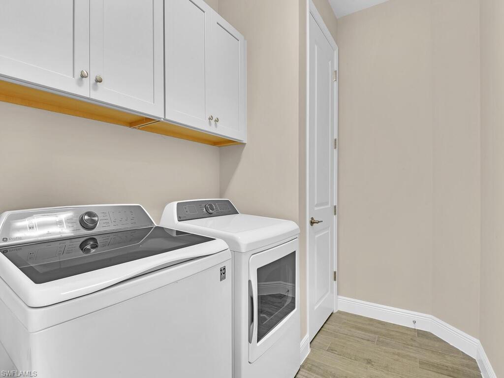 2561 Seychelles Drive, Unit 308 Naples, FL 34112 - Photo 20 of 28 a utility room with dryer and washer