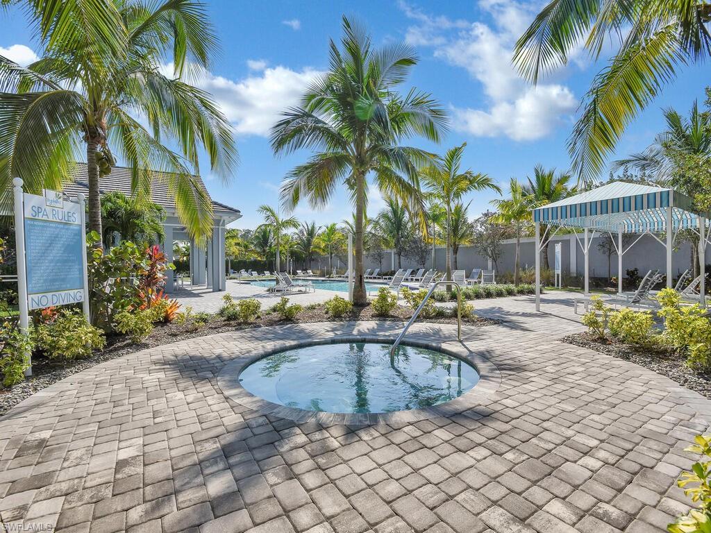 2561 Seychelles Drive, Unit 308 Naples, FL 34112 - Photo 26 of 28 a view of a house with swimming pool and sitting area