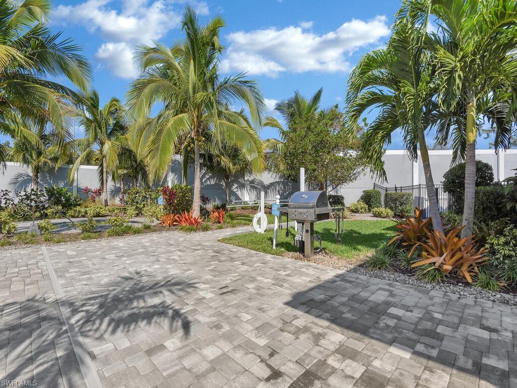 2561 Seychelles Drive, Unit 308 Naples, FL 34112 - Photo 27 of 28 a view of a yard with a patio