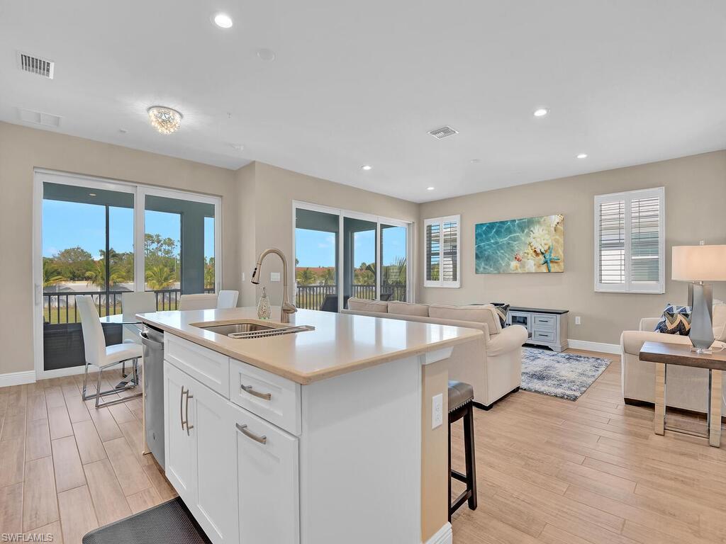 2561 Seychelles Drive, Unit 308 Naples, FL 34112 - Photo 4 of 28 a large kitchen with lots of counter space and windows