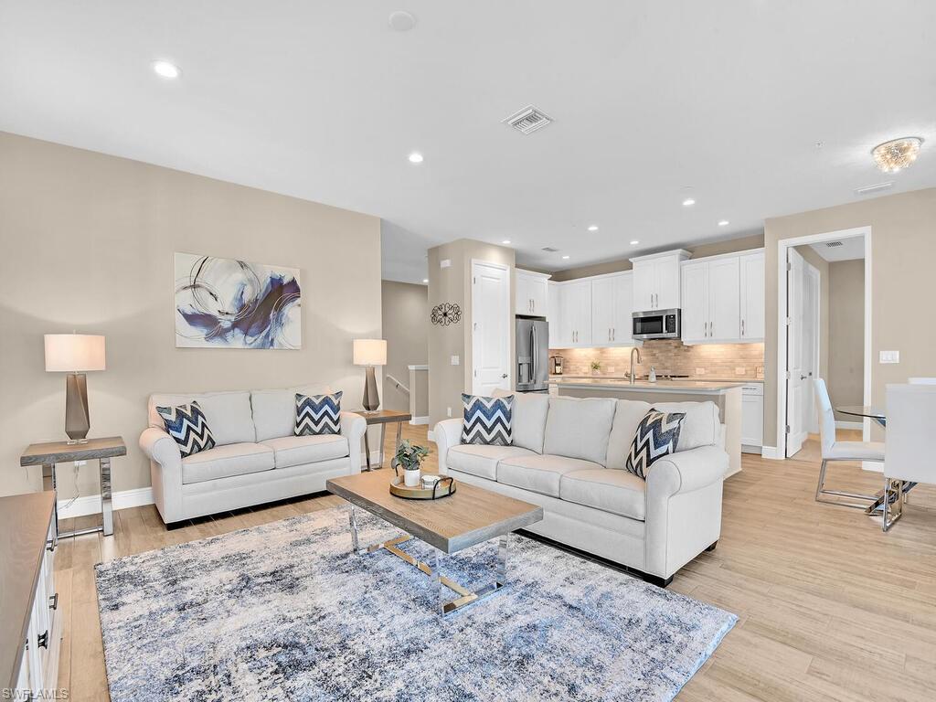 2561 Seychelles Drive, Unit 308 Naples, FL 34112 - Photo 6 of 28 a living room with furniture and view of kitchen