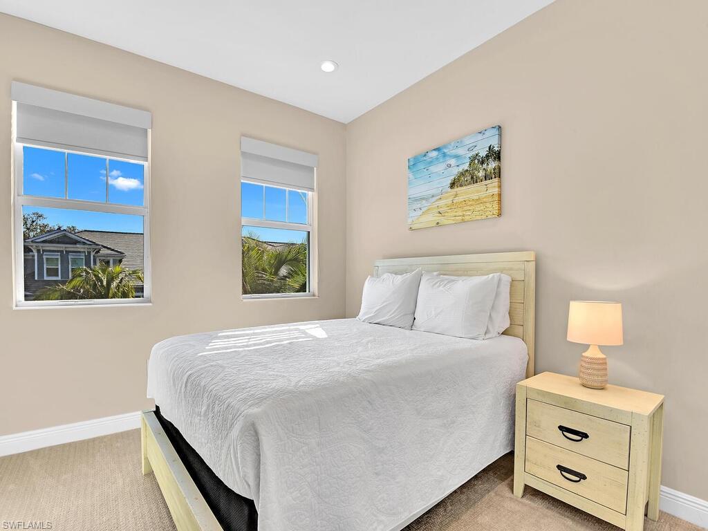 2561 Seychelles Drive, Unit 308 Naples, FL 34112 - Photo 10 of 28 a bedroom with a bed and a window