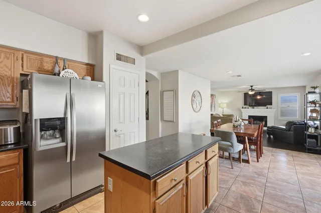 a kitchen with stainless steel appliances a refrigerator a table and chairs