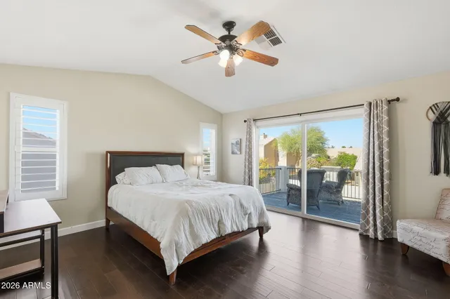 a bedroom with a large bed and a large window