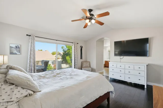 a bedroom with a bed tv and dresser