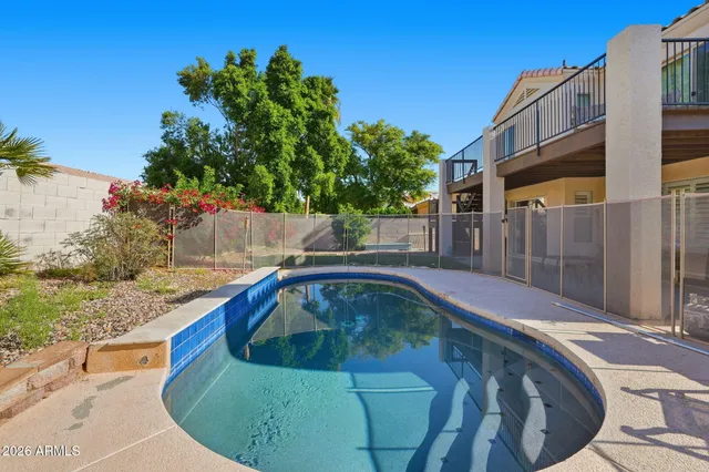 a view of a swimming pool with back yard