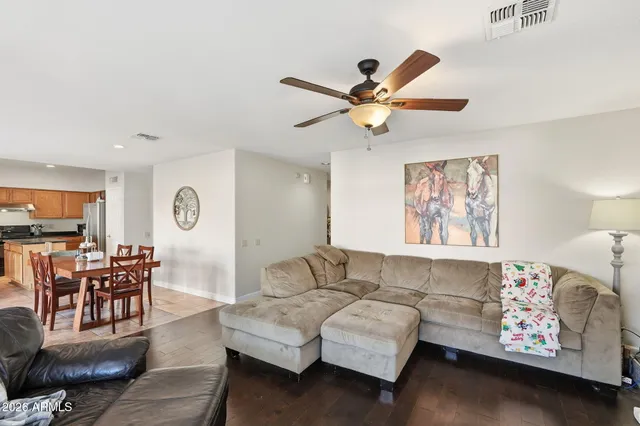 a living room with furniture and wooden floor
