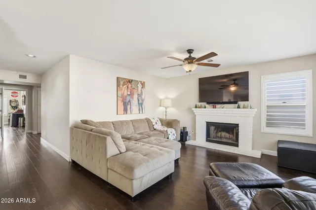 a living room with furniture a fireplace and a flat screen tv