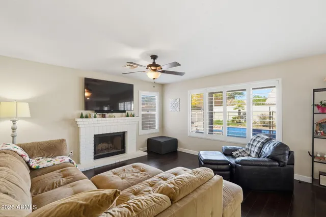 a living room with furniture a flat screen tv and a fireplace
