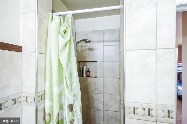 a bathroom with a shower and a sink