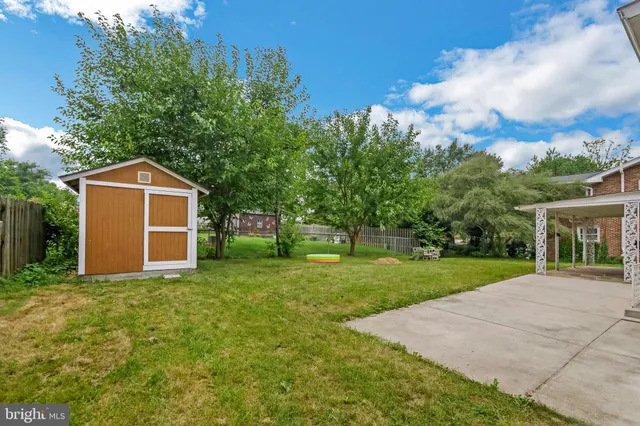 a front view of a house with yard and tree
