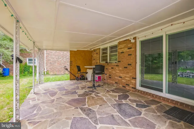 a view of a porch with chairs and floor