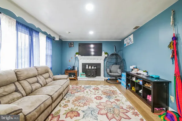 a living room with furniture and a fireplace