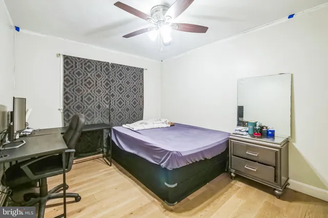 a bedroom with a bed and a desk