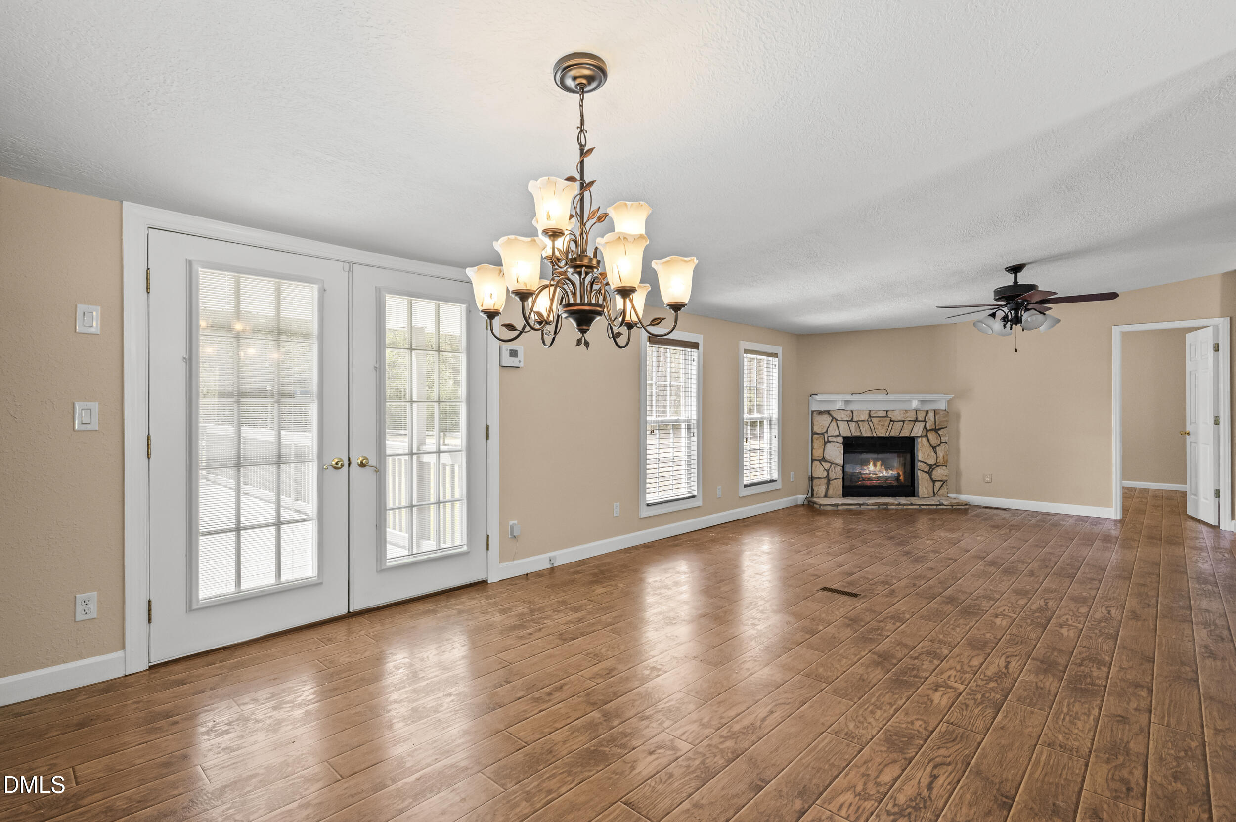 221 Pinkney Church Road Fremont, NC 27830 - Photo 21 of 36 a view of a livingroom with a chandelier fireplace and wooden floor