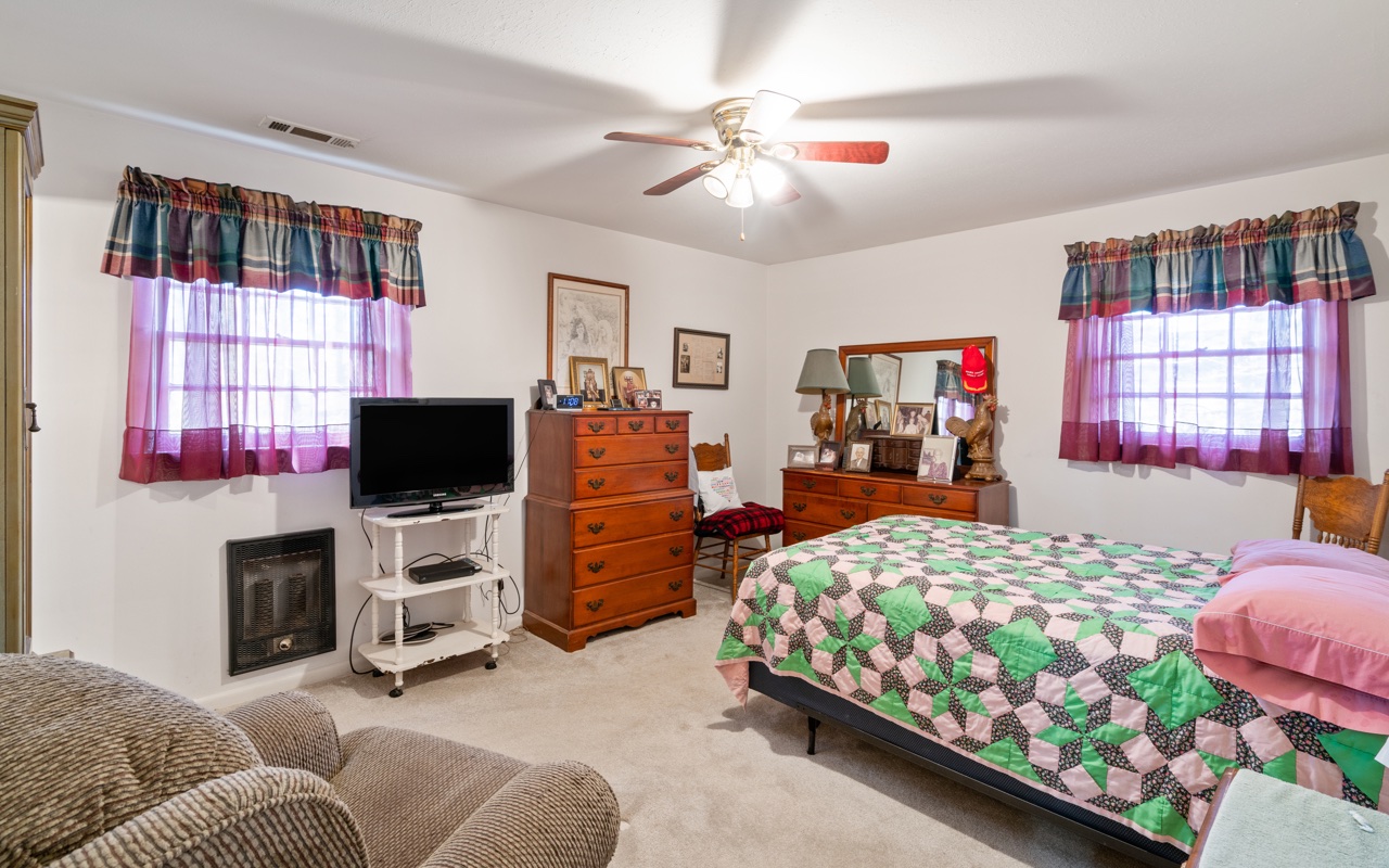 3805 Hilldale Road Oakwood, GA 30566 - Photo 11 of 28 a bedroom with a bed couch and a flat tv screen