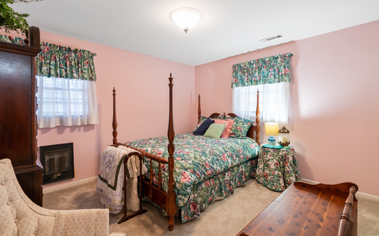 3805 Hilldale Road Oakwood, GA 30566 - Photo 13 of 28 a bedroom with a bed a flat tv screen and a dresser