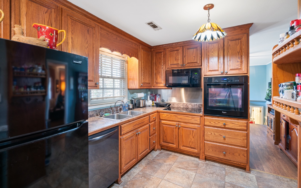3805 Hilldale Road Oakwood, GA 30566 - Photo 5 of 28 a kitchen with granite countertop a sink stove and cabinets