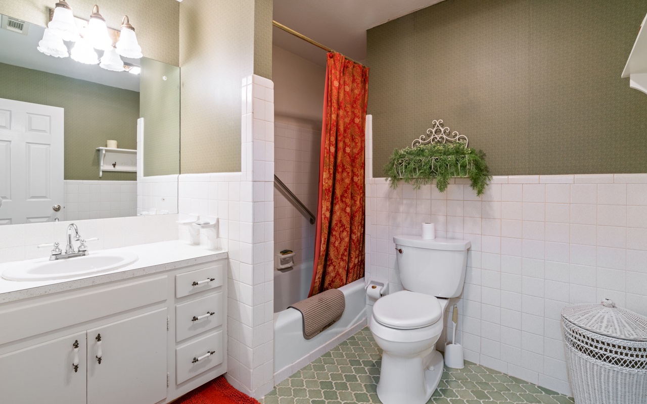 3805 Hilldale Road Oakwood, GA 30566 - Photo 10 of 28 a bathroom with a toilet a sink and mirror