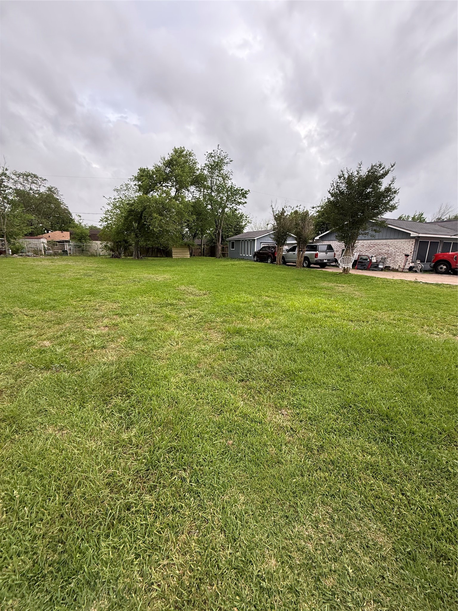 a view of a field of grass and trees