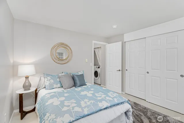 a bedroom with a bed and a lamp