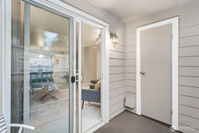 a bathroom with a glass shower door and a mirror