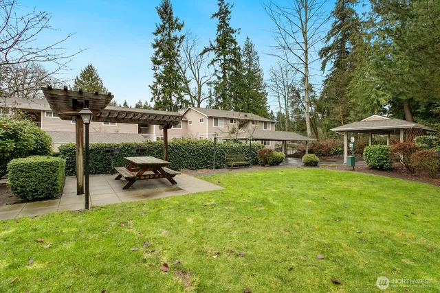 a view of a house with backyard and sitting area