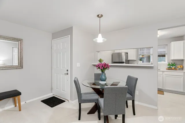 a dining room with furniture and window