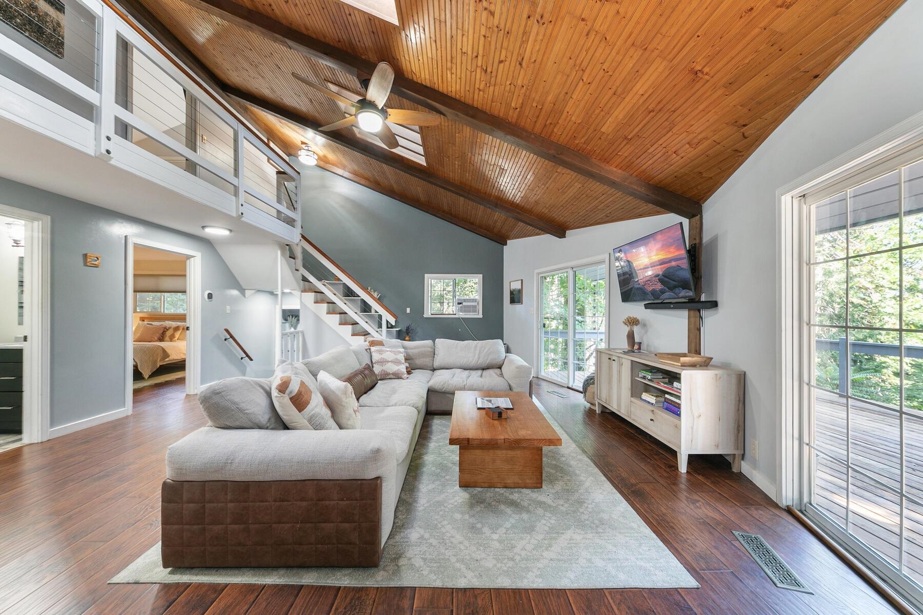 16844 Pasquale Road Nevada City, CA 95959 - Photo 11 of 27 a living room with furniture a flat screen tv and a floor to ceiling window