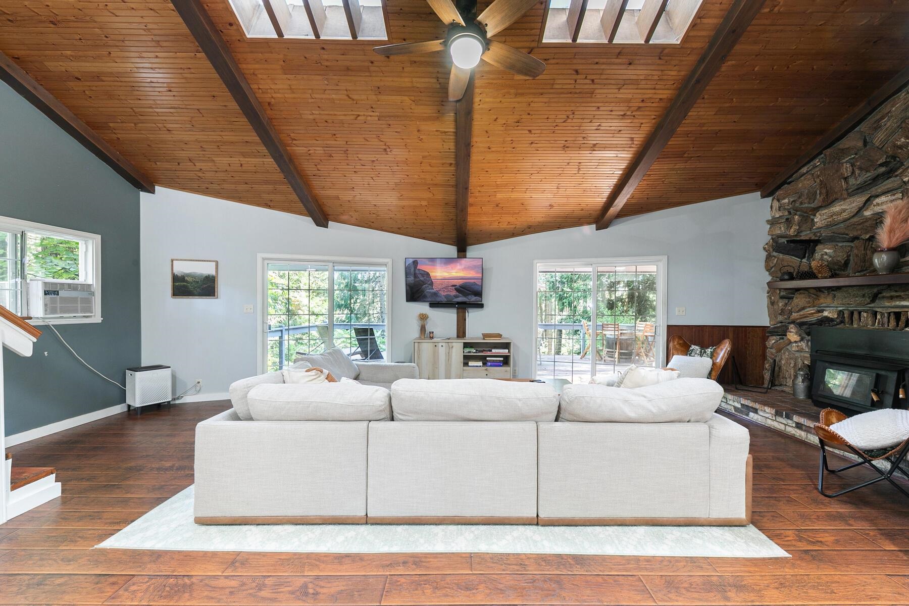 16844 Pasquale Road Nevada City, CA 95959 - Photo 12 of 27 a living room with furniture a flat screen tv and a large window