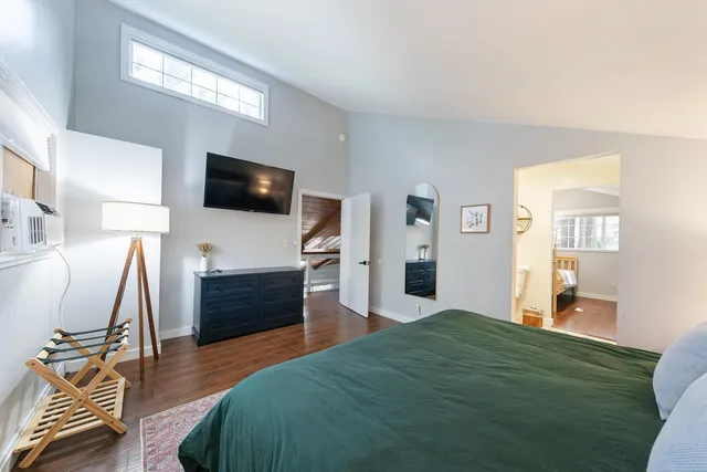 a bedroom with furniture and a flat screen tv
