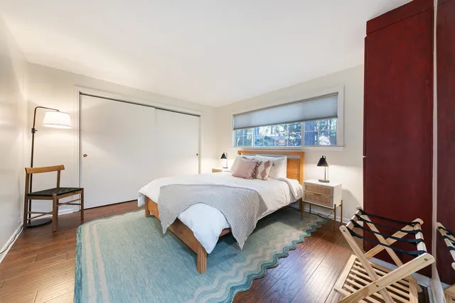 a bedroom with a bed and wooden floor