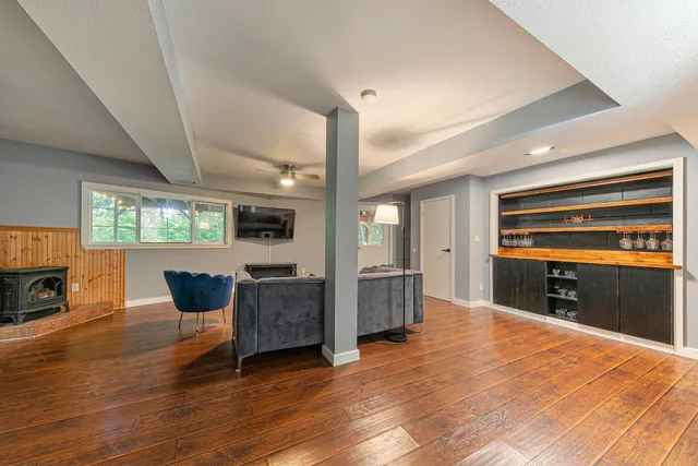 a dining room with furniture a fireplace and wooden floor