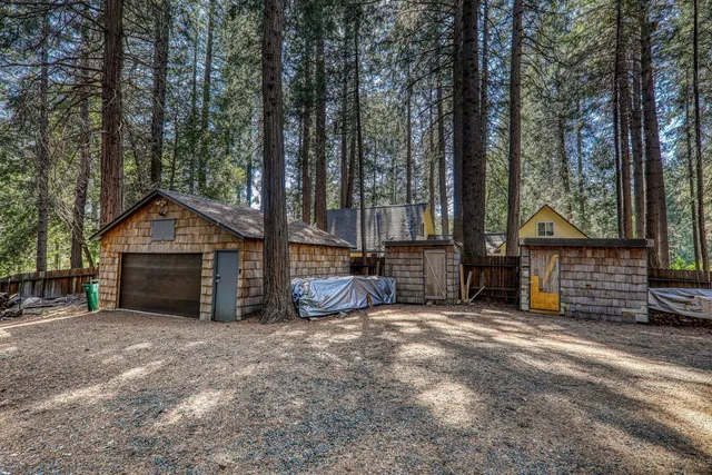 a view of a house with a yard and wooden fence