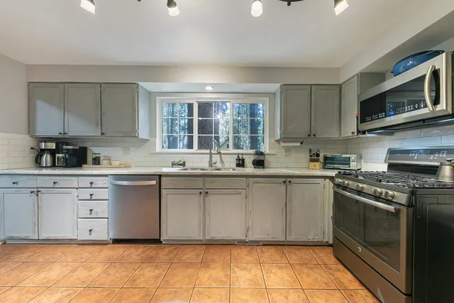 a kitchen with a stove top oven sink and cabinets