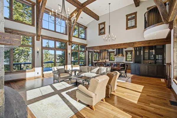 a view of a patio with couches and table potted plants with wooden floor