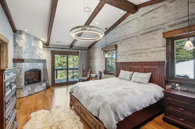 a bed sitting in a spacious bedroom next to a window