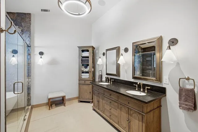 a bathroom with a sink double vanity and a mirror
