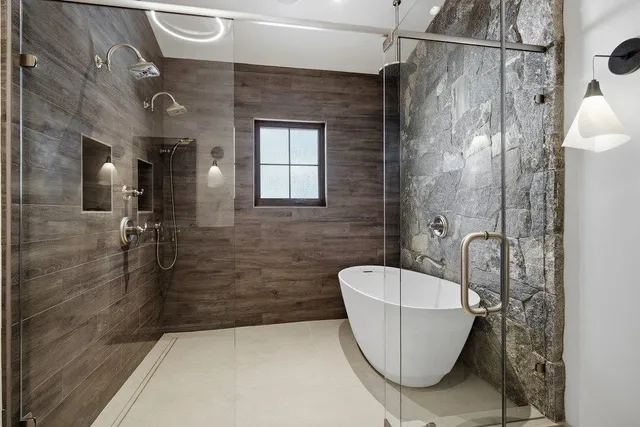 a bathroom with a bathtub and shower