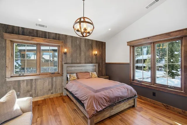 a bedroom with a large bed and a large window