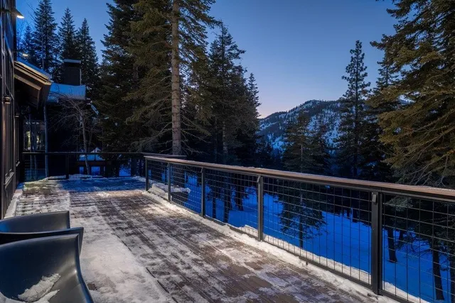 a view of deck with furniture and trees