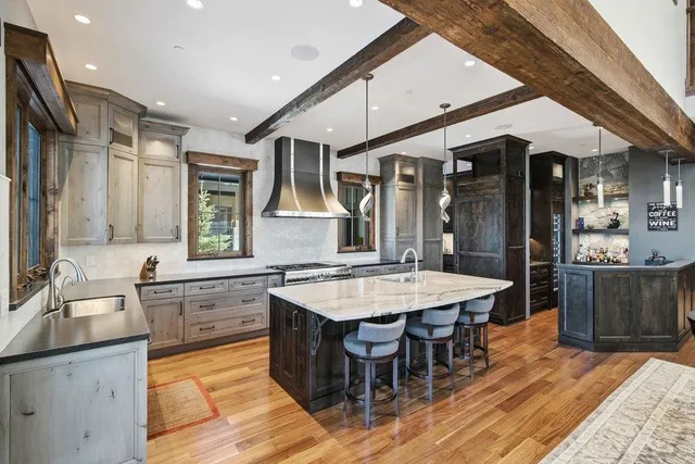 a large kitchen with kitchen island a sink table and chairs