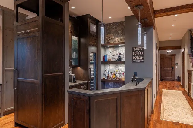 a kitchen with a refrigerator and a stove top oven