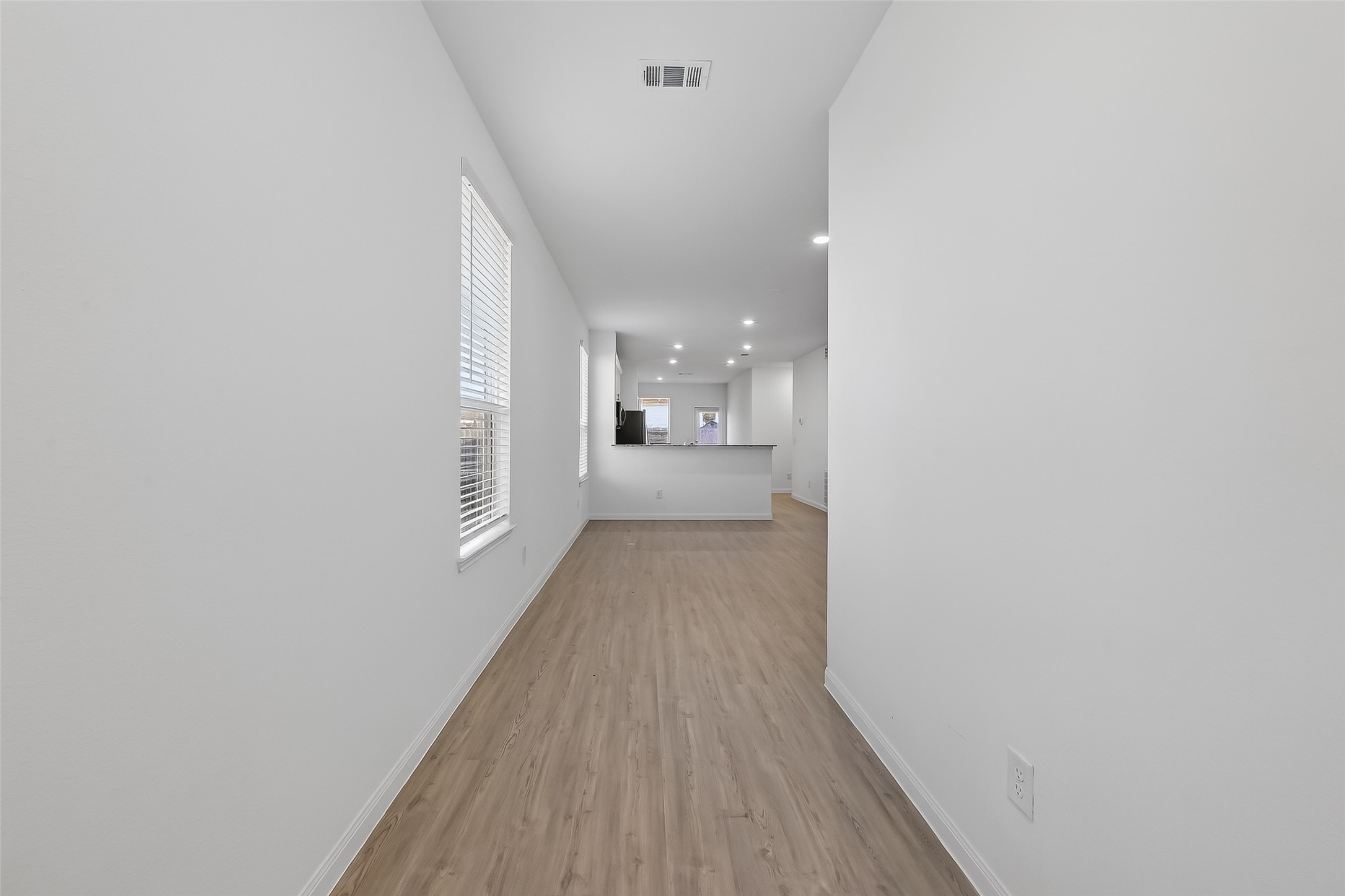 17902 Slurry Rake Lane Hockley, TX 77447 - Photo 14 of 32 a view of a hallway with wooden floor and a bathroom