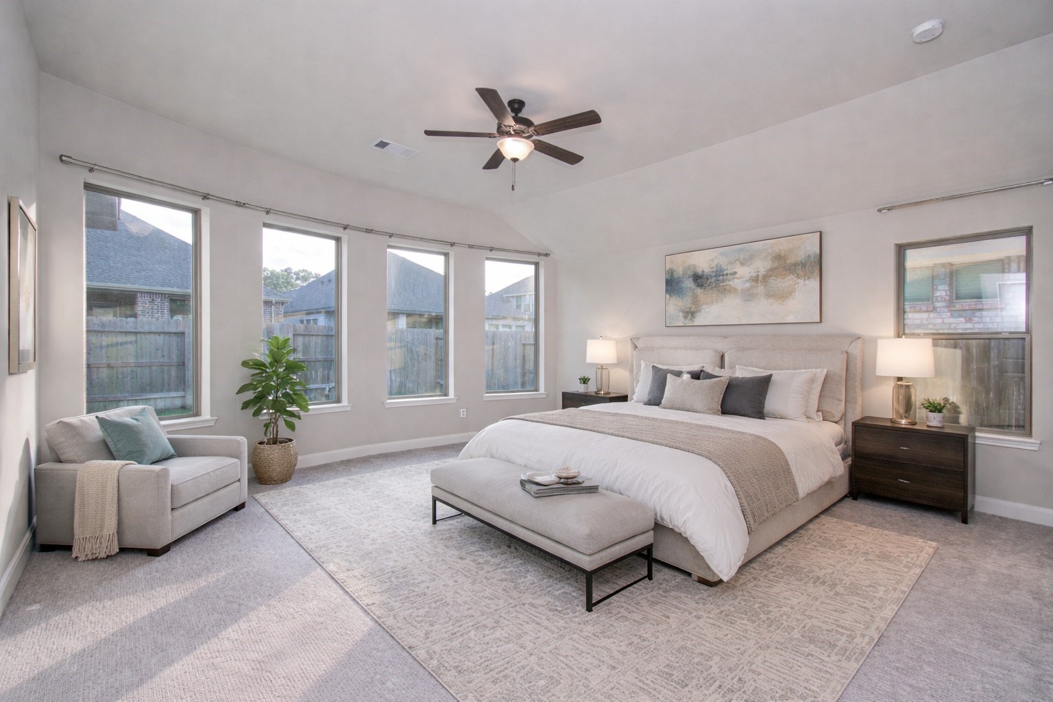 17344 Grand Canyon Road Conroe, TX 77302 - Photo 22 of 49 Spacious, bright bedroom with large windows, neutral tones, and modern decor. Features a comfortable bed, cozy seating area, and stylish furnishings for a serene atmosphere.