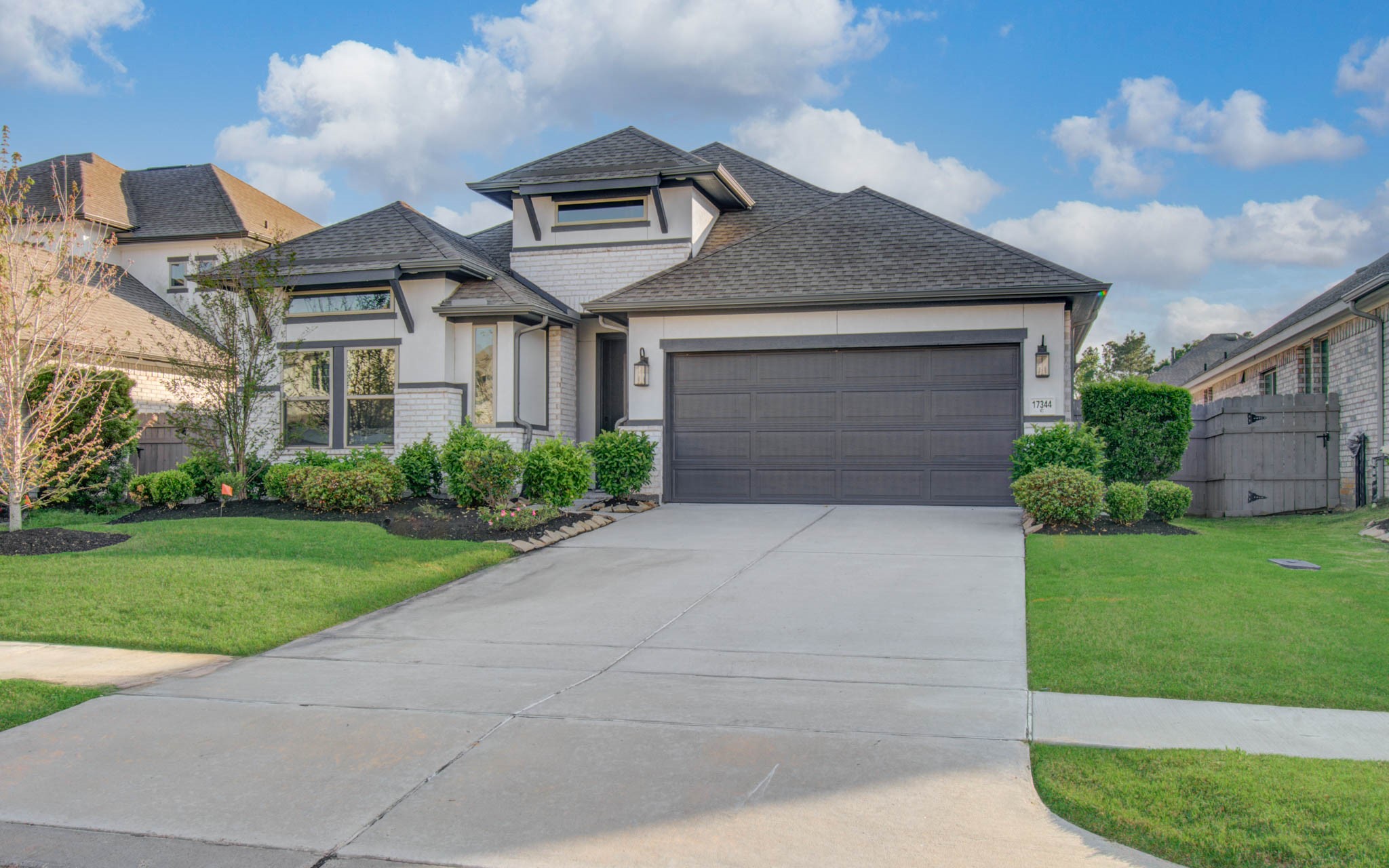17344 Grand Canyon Road Conroe, TX 77302 - Photo 3 of 49 This charming home features a modern design with a dark roof and garage door, complemented by light exterior walls. The well-maintained front yard includes lush greenery and a neat driveway leading to the two-car garage. Ideal for comfortable living in a welcoming neighborhood.