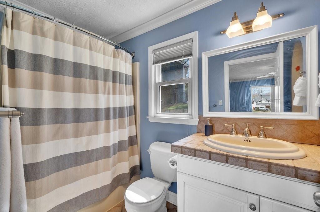 4655 Lake Shore Road North Denver, NC 28037 - Photo 18 of 31 a bathroom with a sink a toilet a mirror and shower curtain