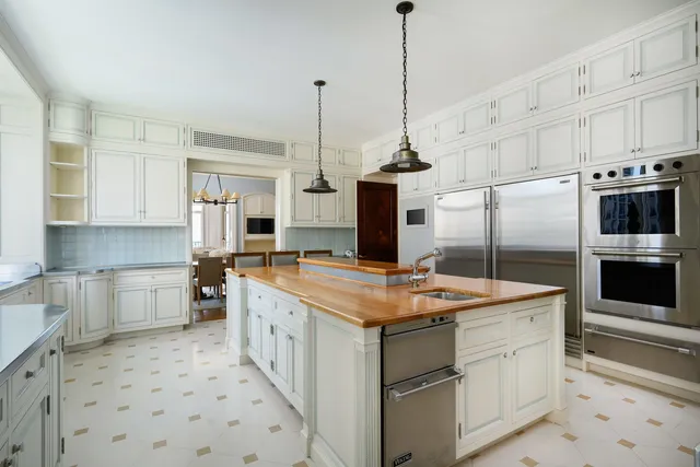 a kitchen that has a sink and a stove in it